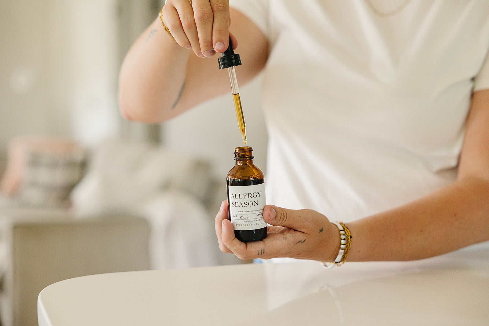 Evergreen Apothecary Allergy Season tincture bottle with label, natural remedy for allergy relief in a clear glass container.