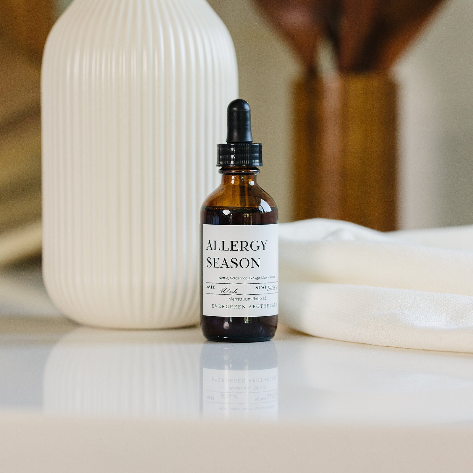 Evergreen Apothecary Allergy Season tincture bottle with label, natural remedy for allergy relief, in a clean, neutral background.
