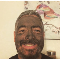 Glimmer Goddess Organic Dead Sea Mud Mask for exfoliating and rejuvenating skin, featuring a 2 oz jar of natural skincare mask.