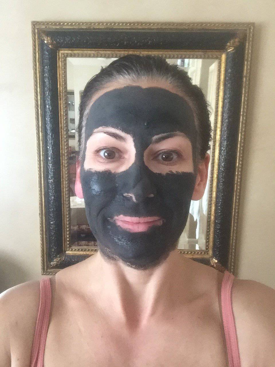 Glimmer Goddess Organic Dead Sea Mud Mask for exfoliating and rejuvenating skin, in a 2 oz jar with a natural clay texture.