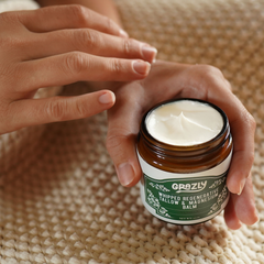 Unlabeled jar of Grazly Dead Sea Magnesium and Tallow Balm showing the unscented balm in a clear container with a white lid