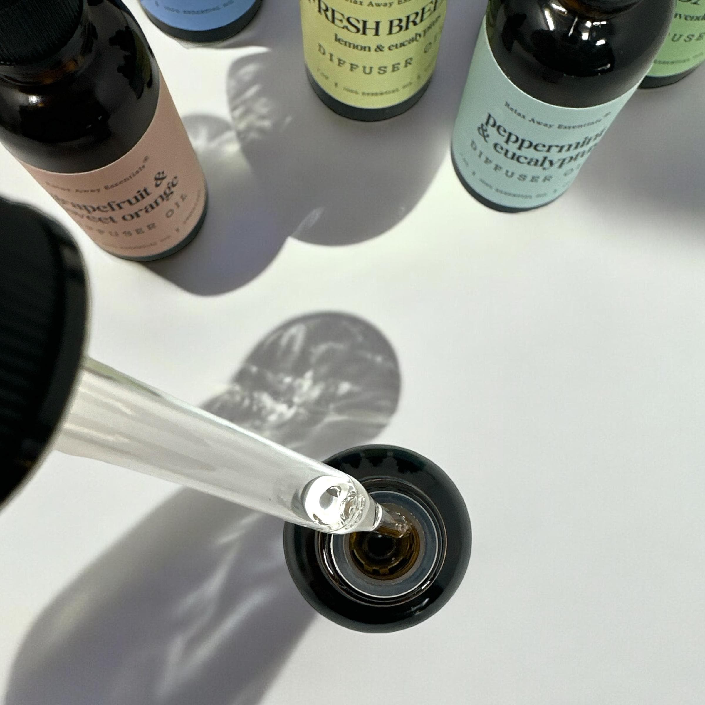 Relax Away Essentials aromatherapy diffuser oils in 1 oz bottles featuring lavender, peppermint, and citrus for relaxation and stress relief.