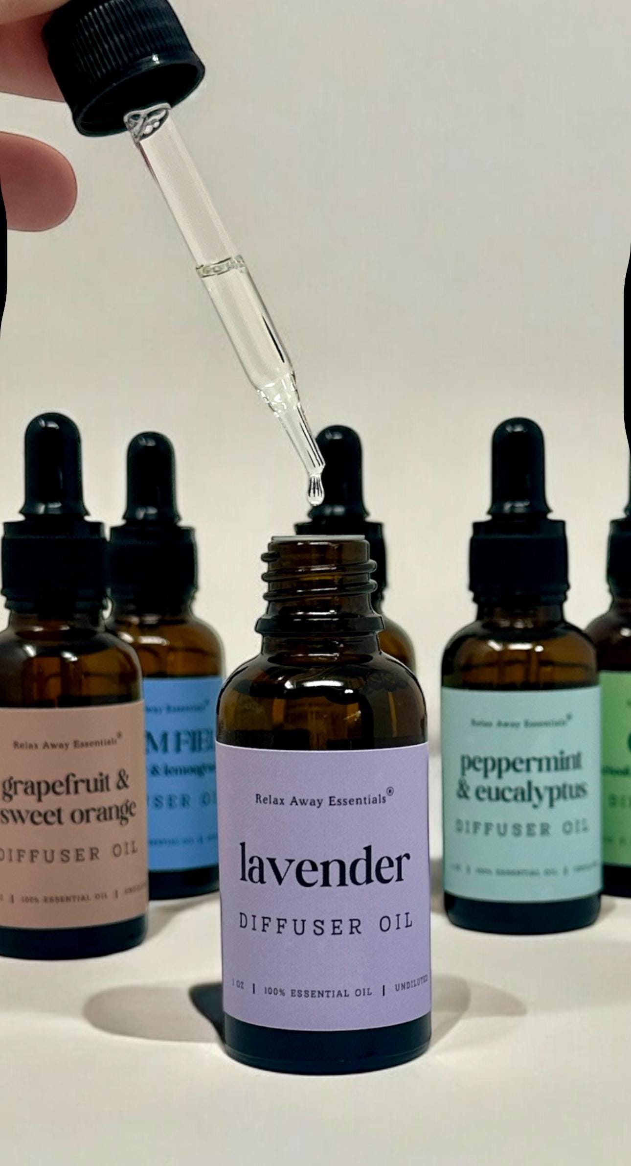 Relax Away Essentials aromatherapy diffuser oils in 1 oz bottles with lavender, peppermint, and citrus scents for stress relief.
