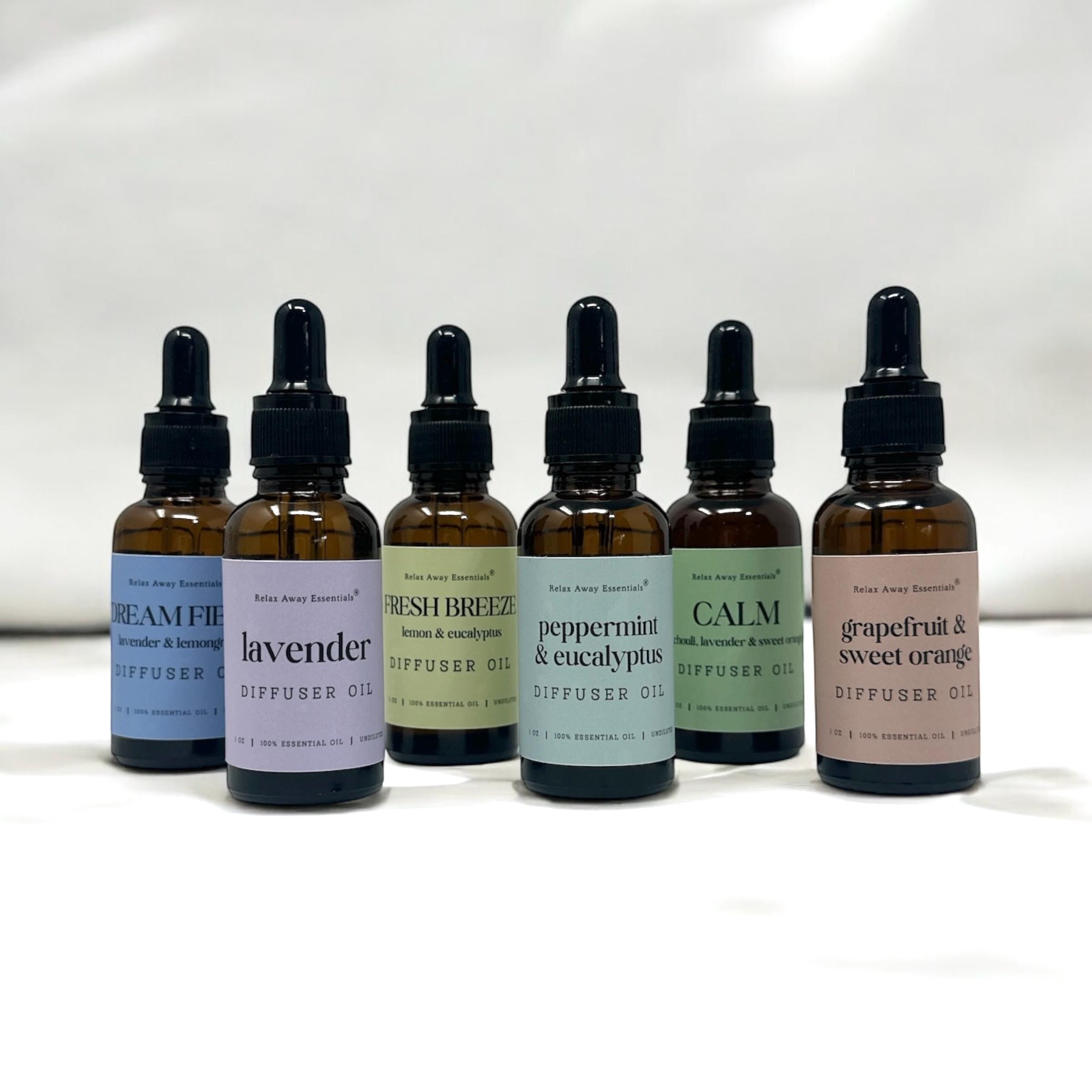 Relax Away Essentials aromatherapy diffuser oils in 1 oz bottles, featuring lavender, peppermint, and citrus scents for stress relief.