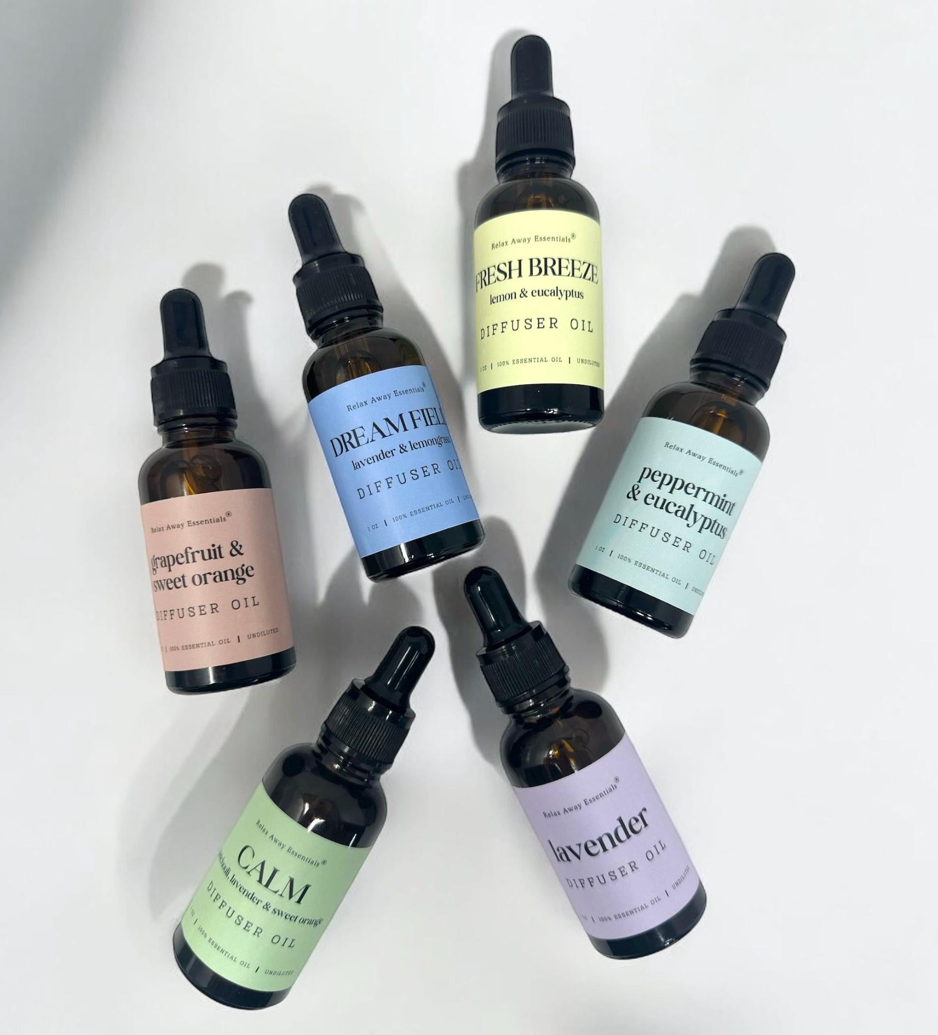 Relax Away Essentials aromatherapy diffuser oils in 1 oz bottles, featuring lavender, peppermint, and citrus scents for stress relief.