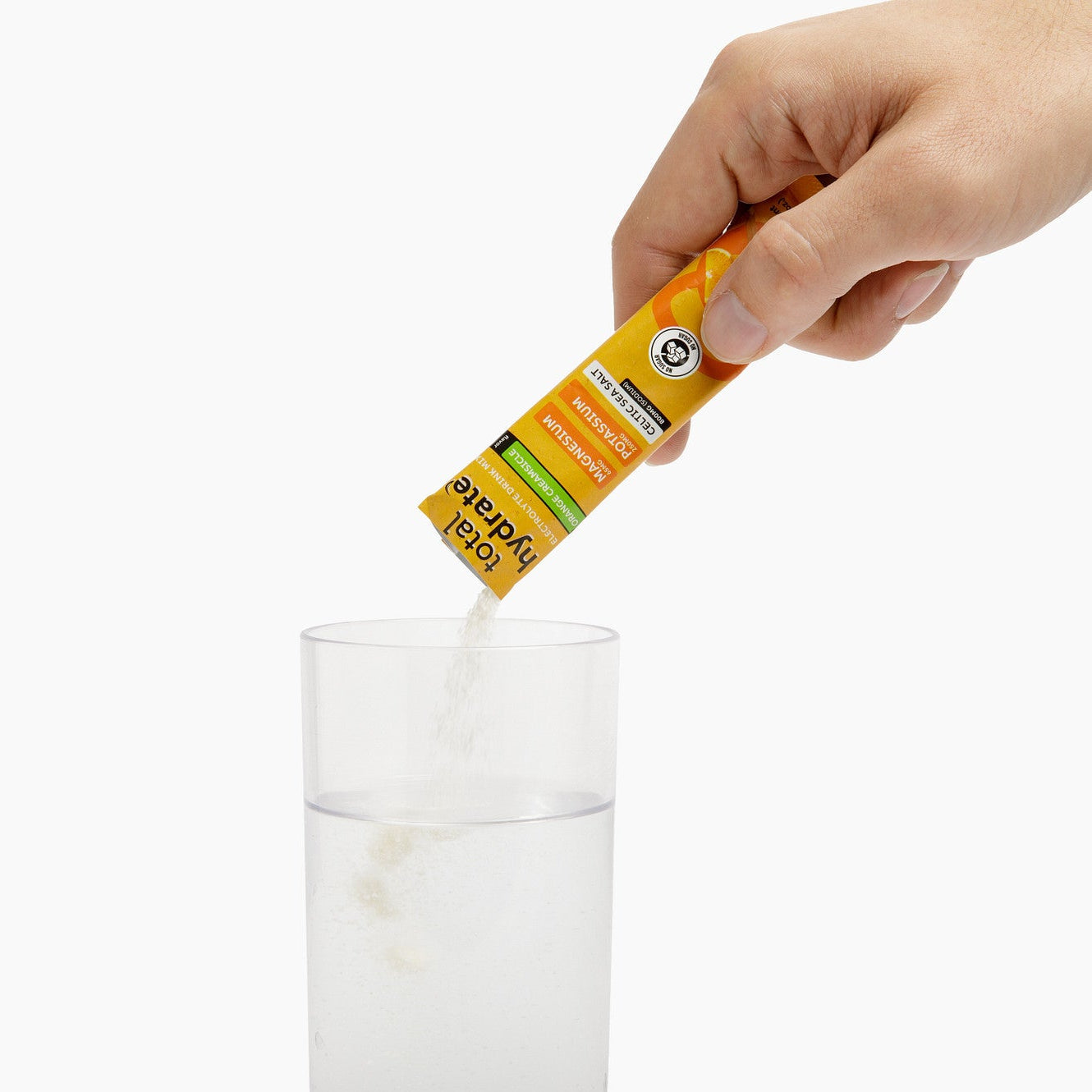 Iron Age Nutrition Total Hydrate electrolyte powder in Orange Creamsicle flavor, showing the orange and cream-colored powder in a scoop.