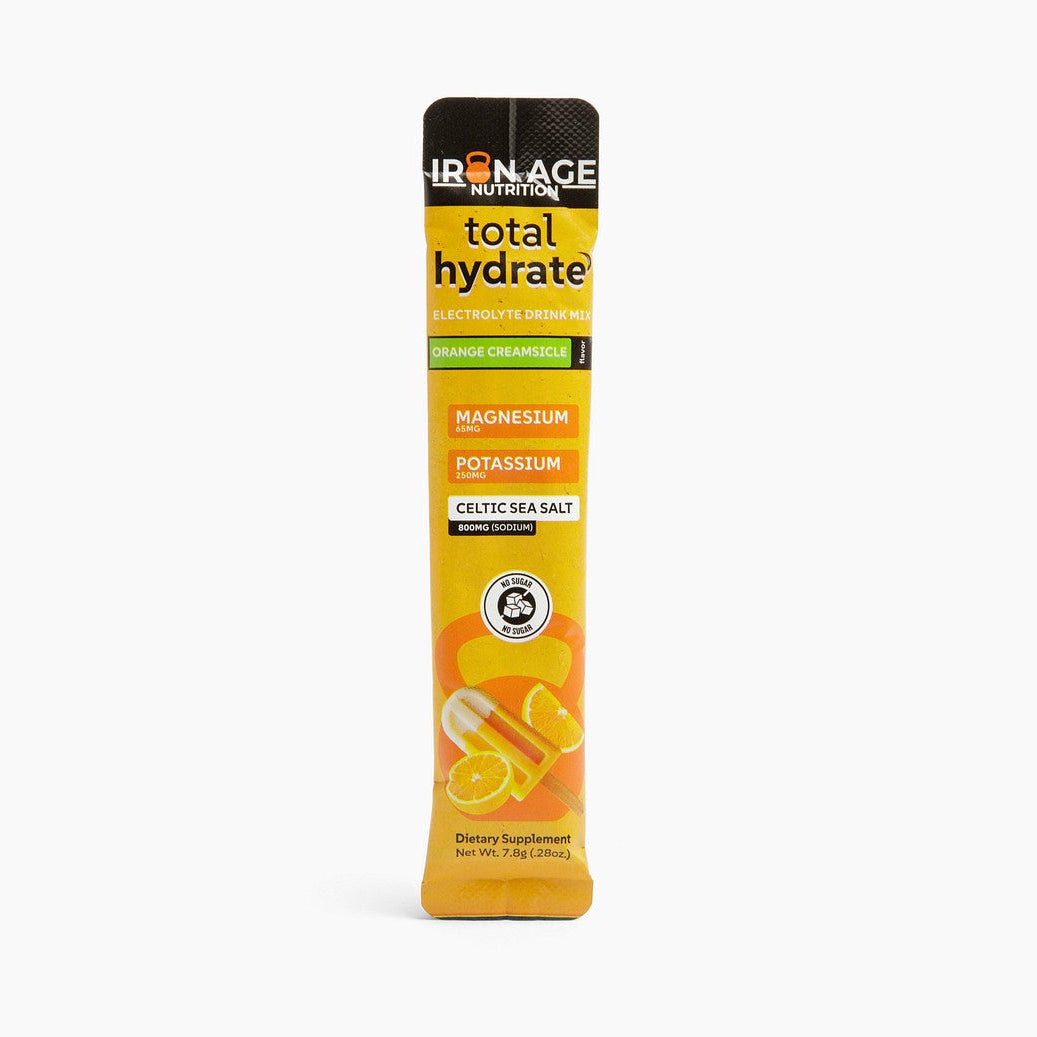 Iron Age Nutrition Total Hydrate electrolyte powder in Orange Creamsicle flavor, showing the colorful powder and packaging.