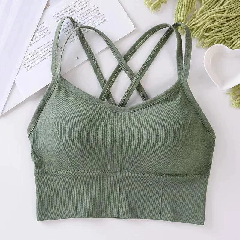 Mandotos women's sports bra with back cross straps, push-up design, breathable fabric, solid color, ideal for yoga and running.