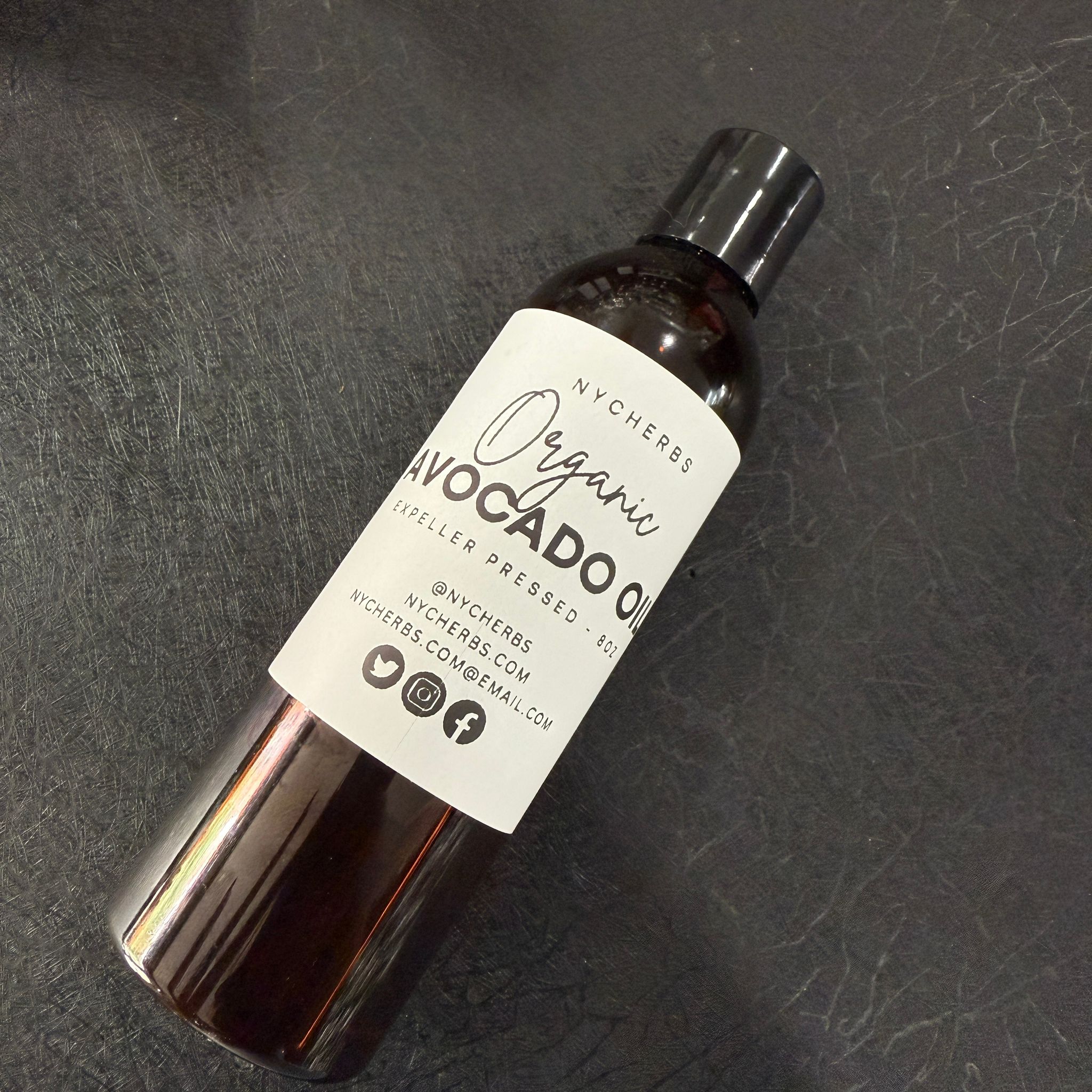 NYC Herbs® Avocado Oil in 4 oz bottle, rich in vitamins A, D, and E, shown in a clear glass bottle with a green label.