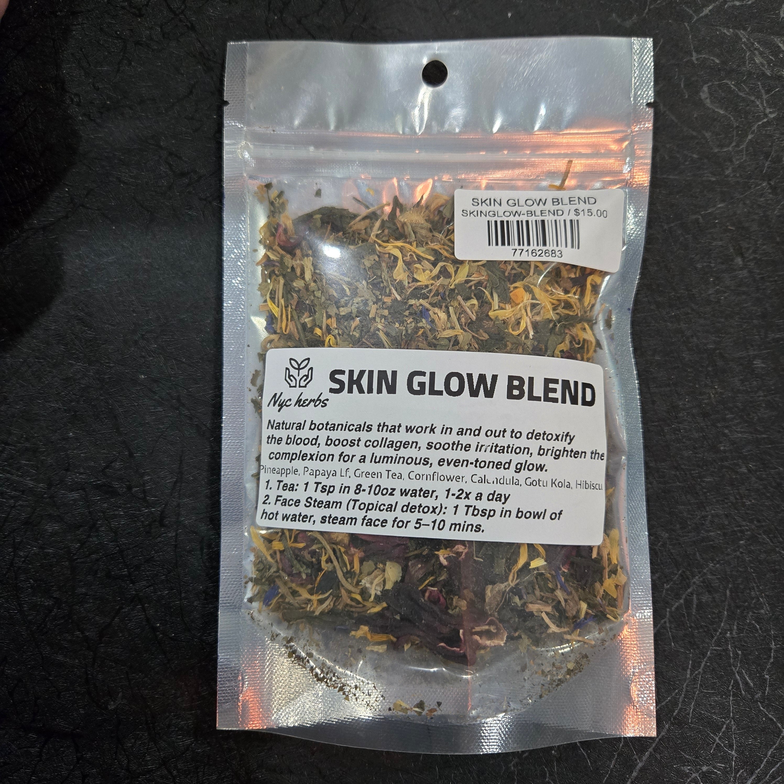 Herbal tea blend for skin glow by NYC Herbs®, featuring dried herbs and botanicals in a glass jar with a tea infuser.