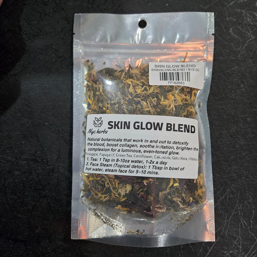 Herbal tea blend for skin glow by NYC Herbs®, featuring dried herbs and botanicals in a glass jar with a tea infuser.