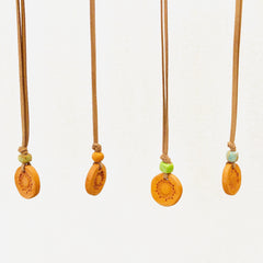 Aromatherapy medallion necklace with a silver pendant and chain, designed for relaxation and stylish wear.