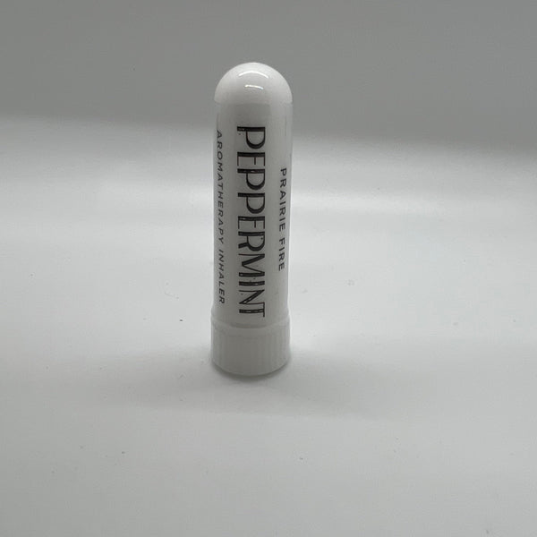 Peppermint aromatherapy inhaler from Prairie Fire Tallow, Candles, and Lavender, featuring a small portable inhaler with peppermint leaves.