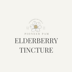 Elderberry tincture bottle from Pioneer Pam for immune system support, with fresh elderberries and dropper cap.