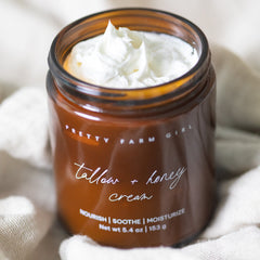 Cream jar of Pretty Farm Girl fragrance-free Tallow and Honey Cream, showing the natural, creamy texture and label.