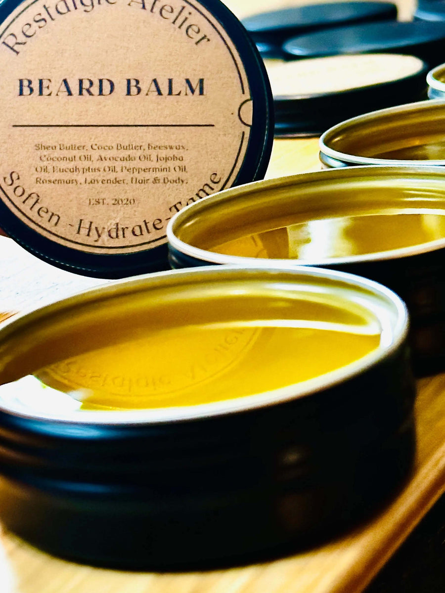 Restalgic Atelier luxury beard balm in a 2oz jar, showing a sleek black container with a gold lid and natural beard care ingredients