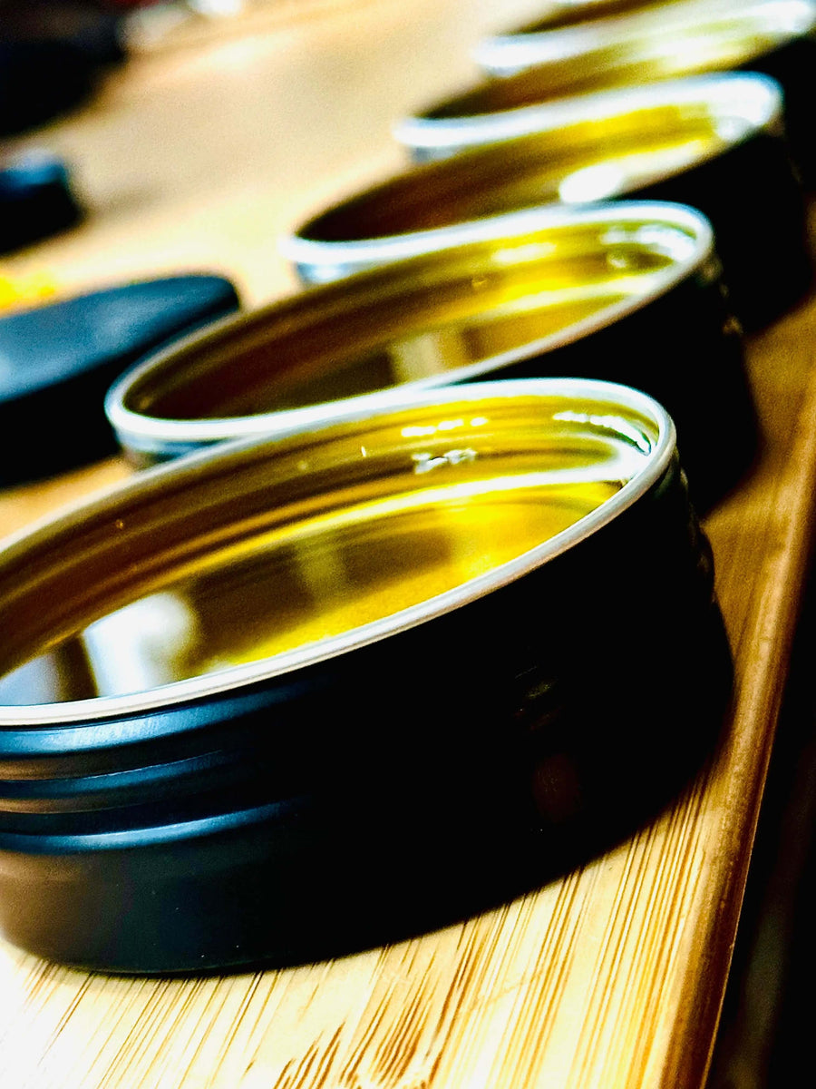 Restalgic Atelier Luxury Beard Balm 2oz jar with a natural wood lid and sleek packaging, designed for grooming and beard care.