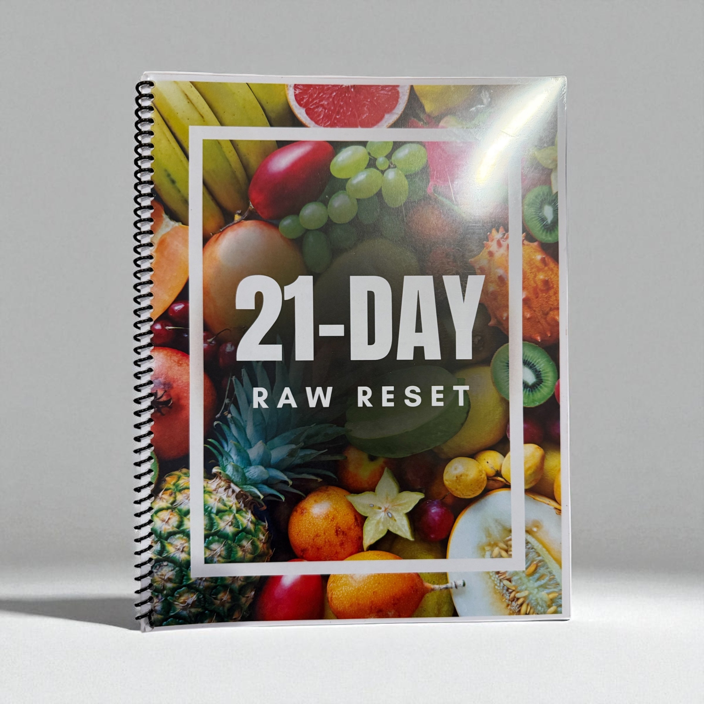 Hard copy of the 21-Day Raw Detox Meal Plan book by Seamoss Depot, featuring raw food recipes for weight loss and gut health.