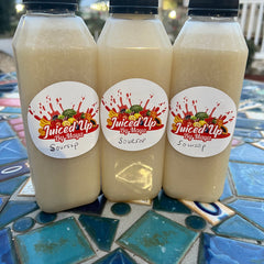 Fresh soursop juice in a 16oz bottle with ginger and organic lime, showcasing a natural, vegan, keto-friendly drink.