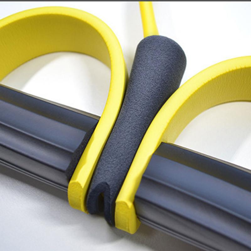 Green natural latex foot pedal elastic pull rope with handle for fitness, bodybuilding, and exercise training.