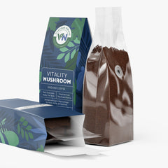 Vitalidad Natural Vitality Mushroom Coffee in medium roast, showing a steaming cup with coffee beans and mushroom extract ingredients.