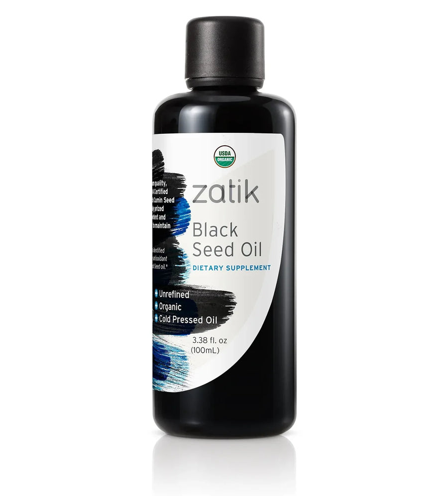 Dark glass bottle of Zatik Naturals Black Seed Oil for health care, with a dropper cap and label showing product details.
