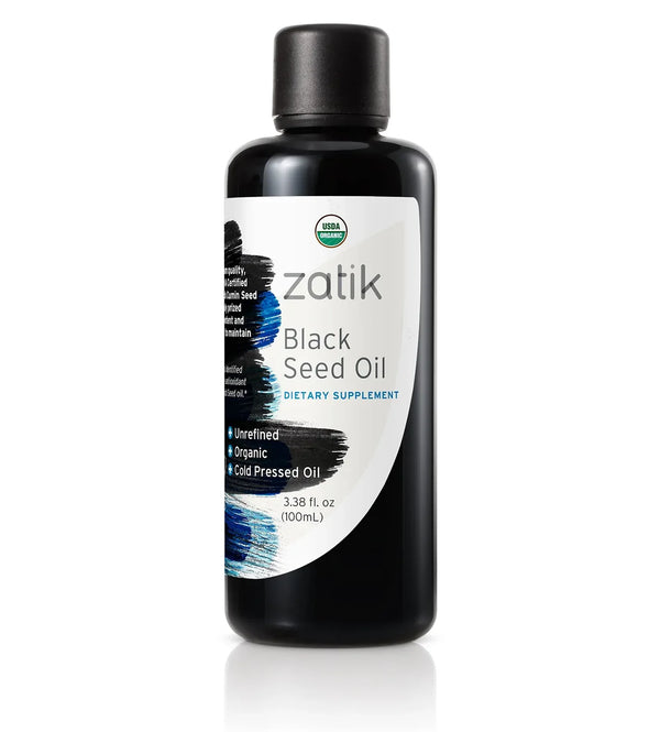 Dark glass bottle of Zatik Naturals Black Seed Oil for health care, with a dropper cap and label showing product details.