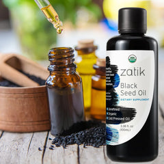 Dark glass bottle of Zatik Naturals Black Seed Oil for health care, with a label detailing its natural ingredients and benefits.
